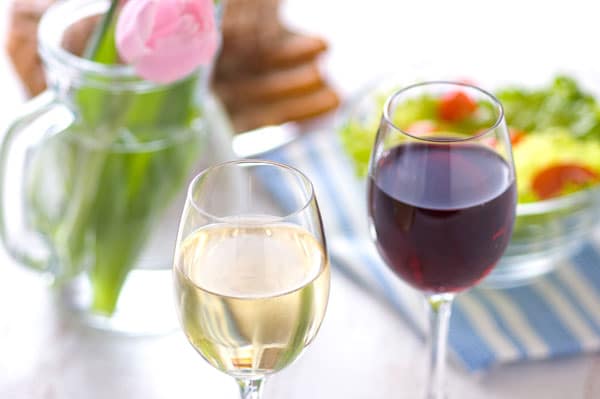 closeup image of glasses of white and red wine