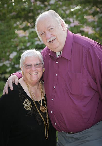 elderly couple smiling for the camera