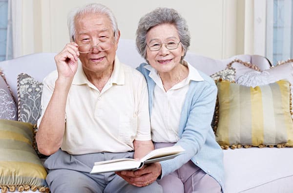 elderly couple smiling at the camera