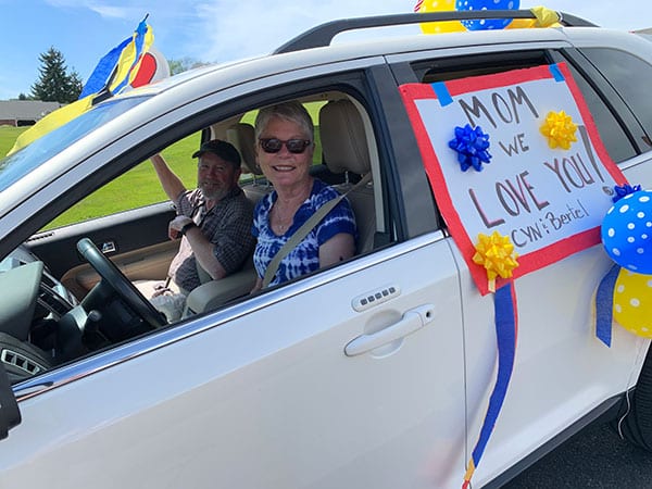 couple riding a car in a parade