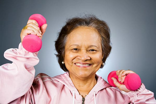 elderly woman lifting hand weights