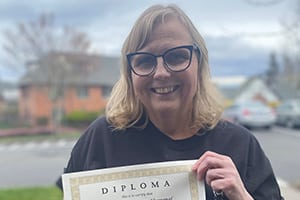 Cheryl holding her diploma