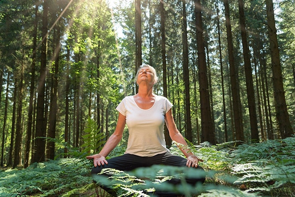 woman doing yoga in a forest