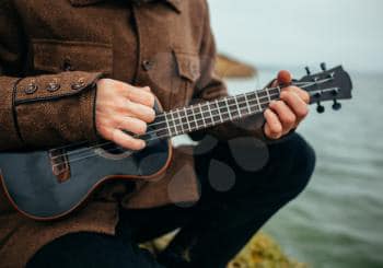 man playing a Ukulele