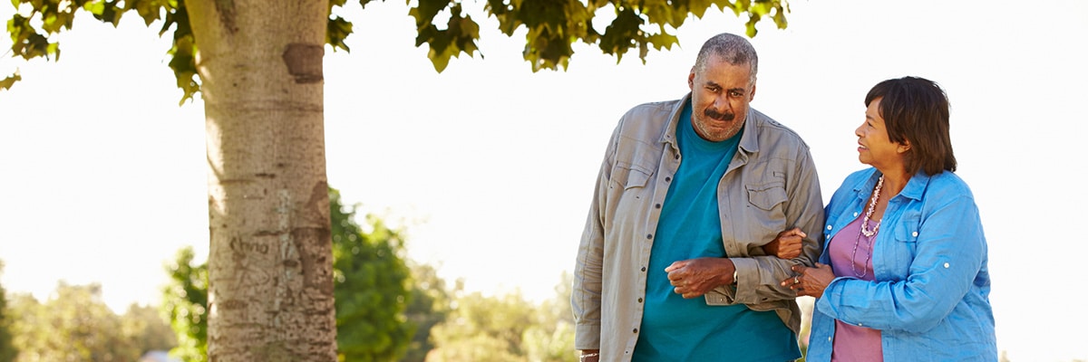 Photograph of Senior Couple Walking In Park Together