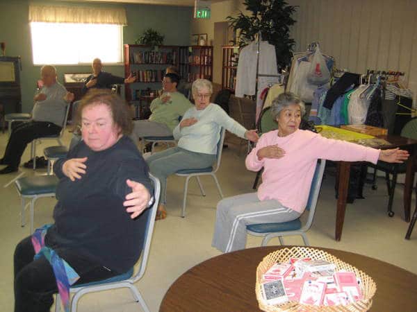 group of seniors doing yoga
