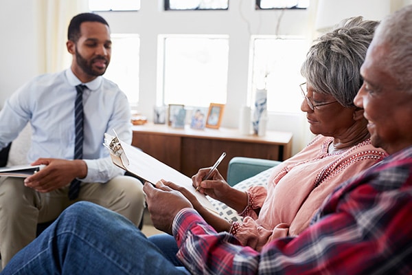 caregiver talking with senior couple