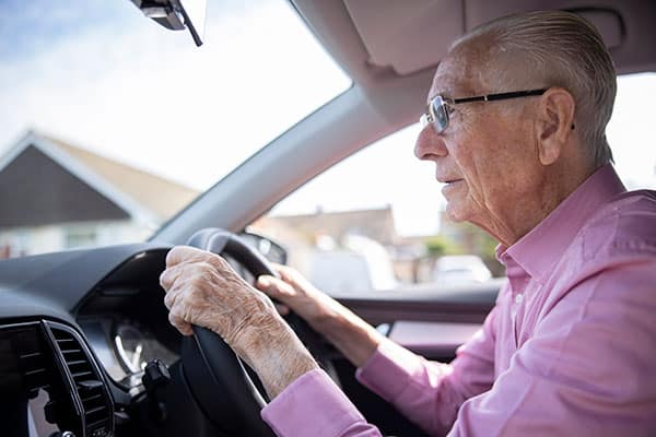 Worried Senior Male Driver Looking Through Car Windshield