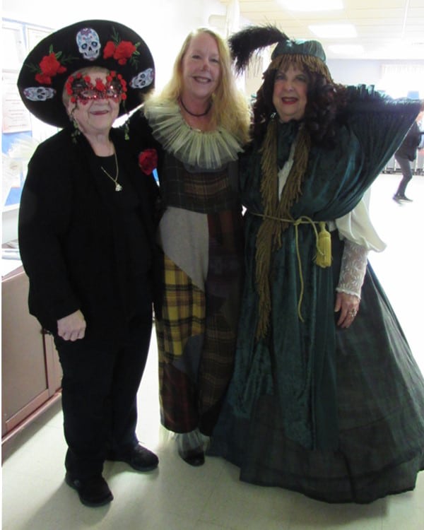 Three women in Halloween costumes.