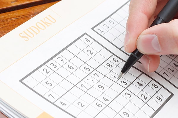 close up of person doing Sudoku