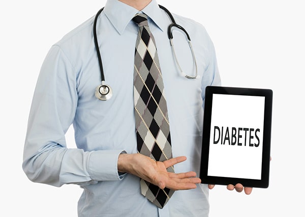 Doctor holding a tablet with the word "Diabetes" displayed on the screen