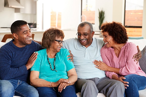 family sitting on a couch laughing