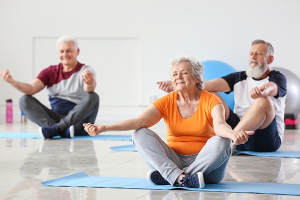 group of seniors doing yoga
