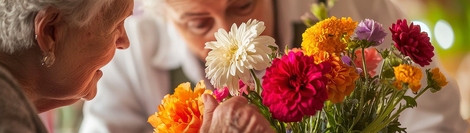 two senior women arranging a bouquet of flowers