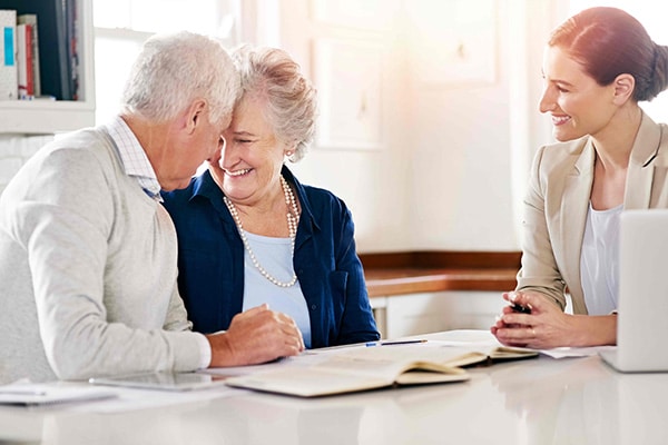 senior couple planning with a caregiver