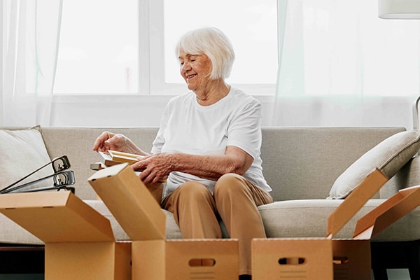 senior couple packing boxes and down sizing