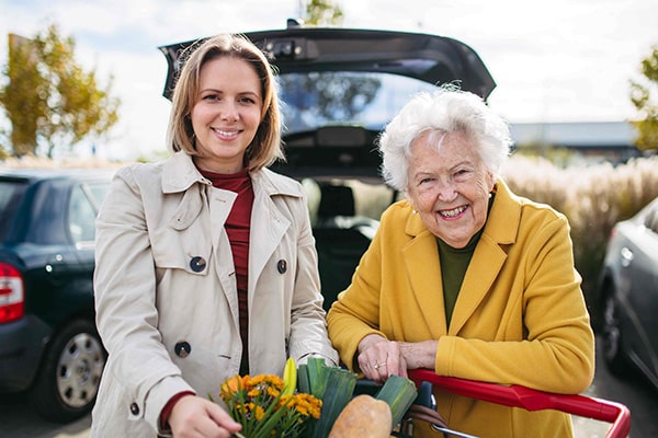 senior woman and daughter grocery shopping