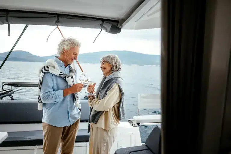 senior couple on a boat drinking white wine