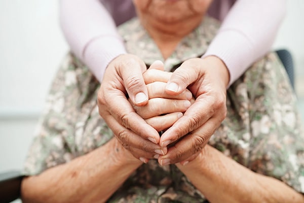 close up of mother and daughter clasping hands