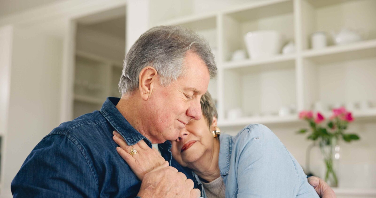 senior couple consoling each other.