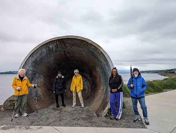 group of people making discoveries on a PNW beach