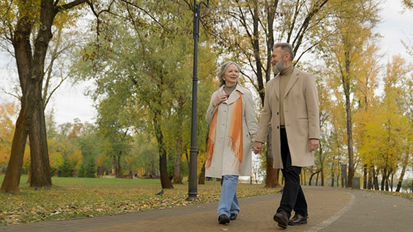 senior couple walking in the woods